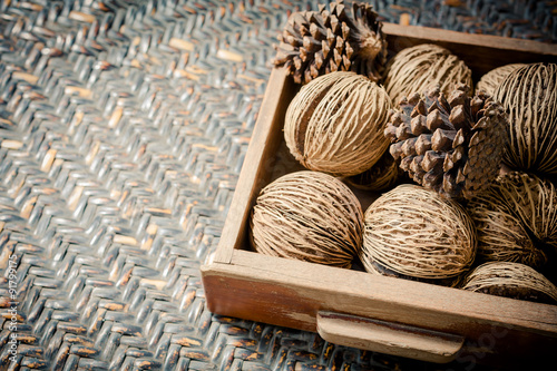 Pine cones in wooden tray