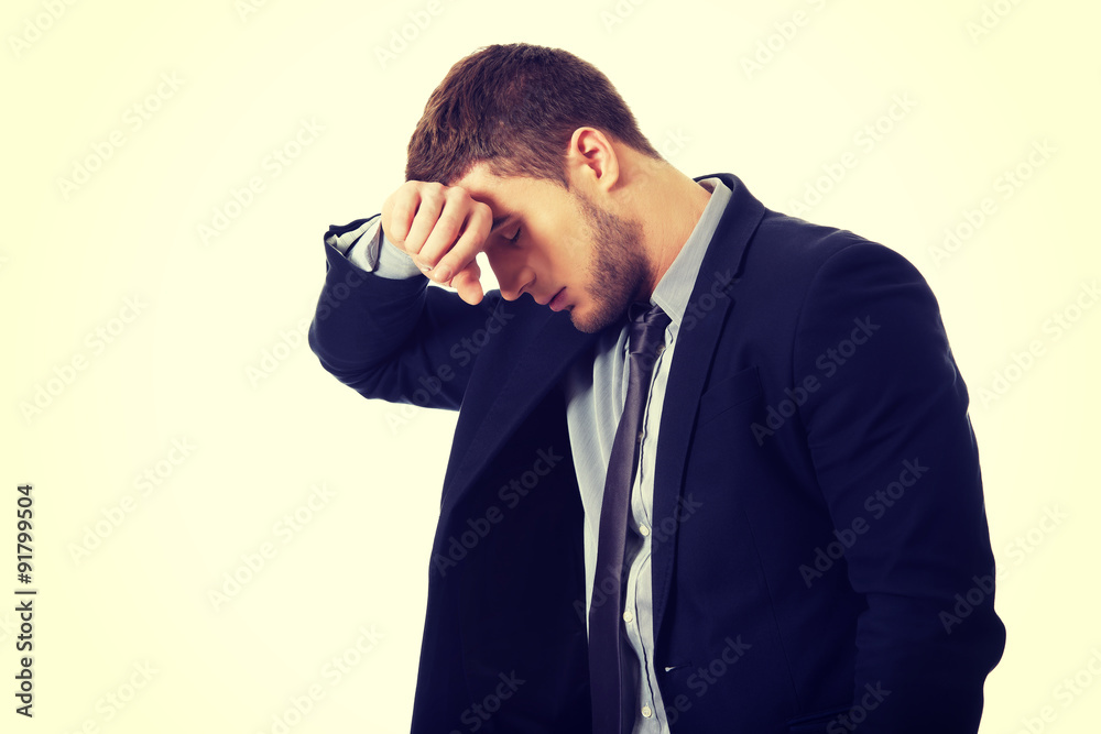 Worried businessman touching his forehead. Worried businessman touching his forehead.