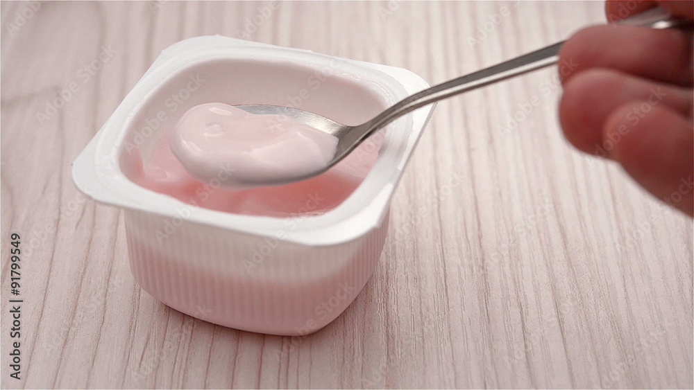 eating strawberry flavor yogurt