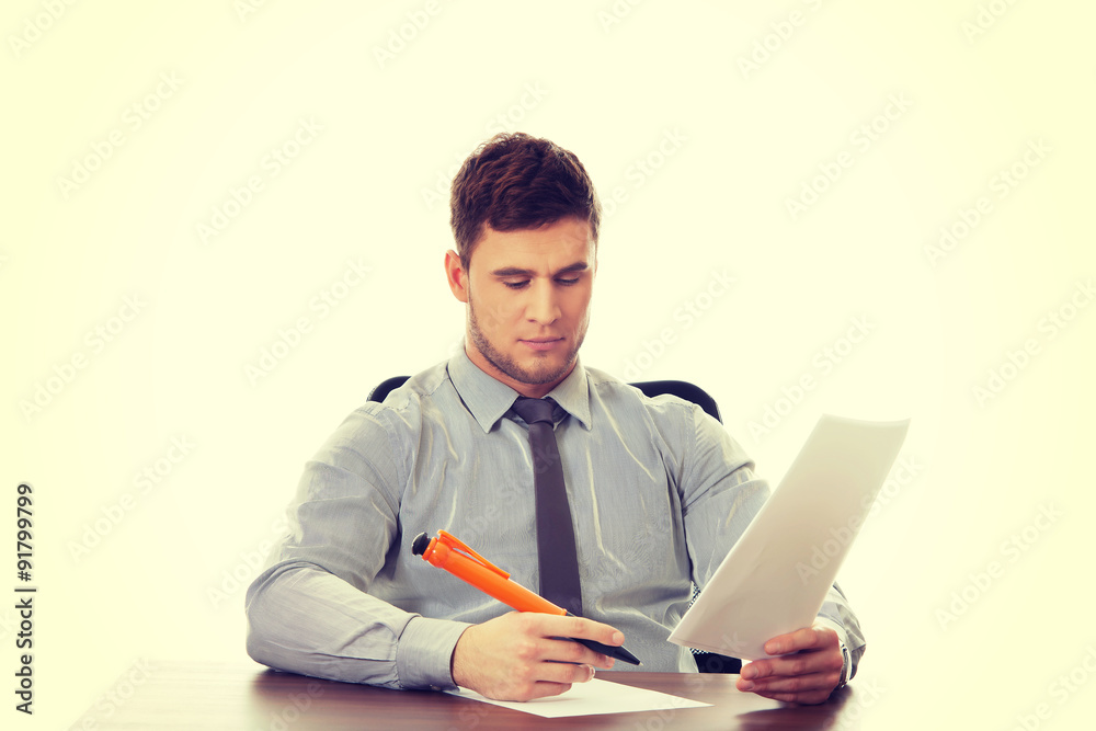 Young business man writing a note. Young business man writing a note.