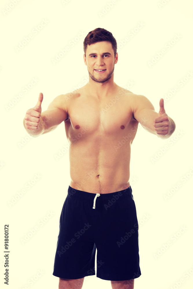 Sexy muscular man showing thumbs up. Sexy muscular man showing thumbs up.