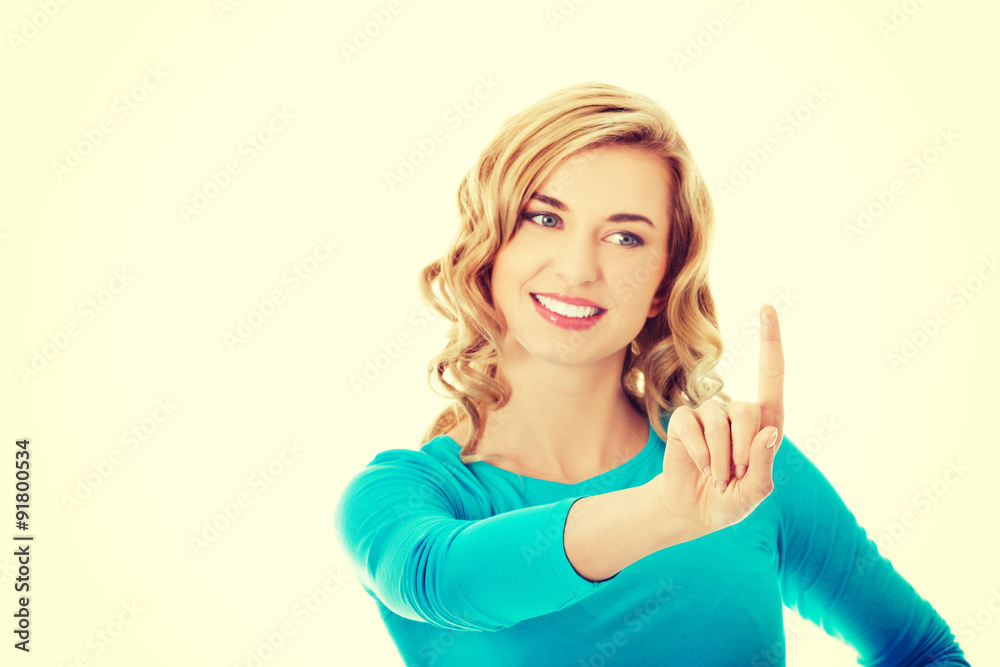 Portrait of woman pushing imaginary button