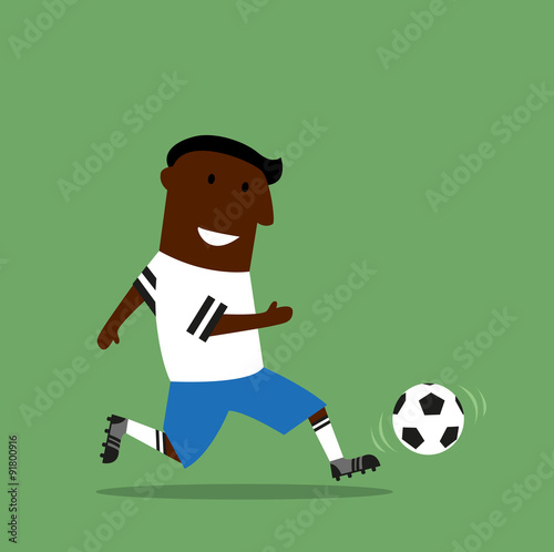 Football or soccer player dribbling a ball