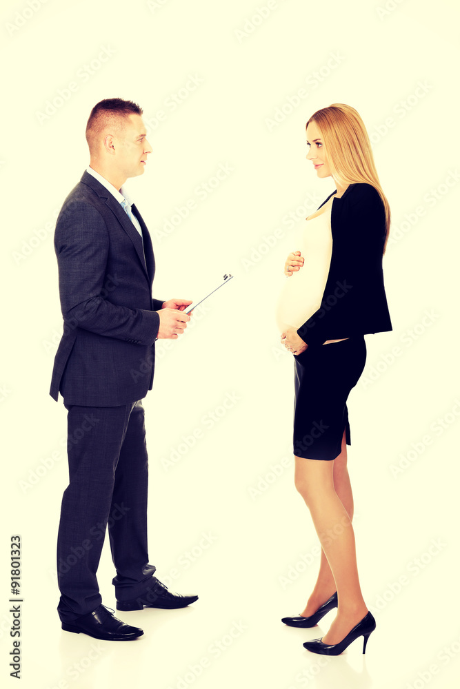 Pregnant businesswoman talking with her partner Pregnant businesswoman talking with her partner