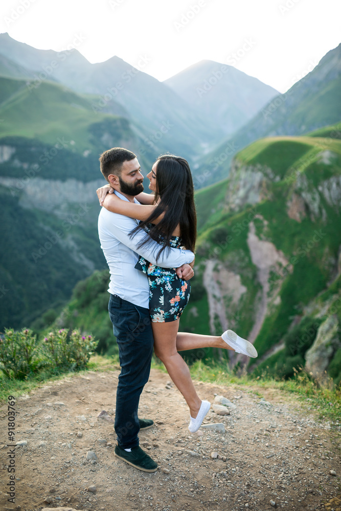 beautiful young couple in love in the mountains