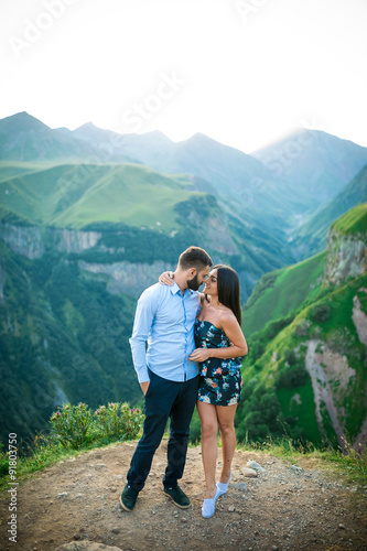 beautiful young couple hugging in the mountains