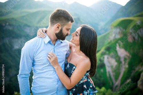 beautiful young couple hugging in the mountains
