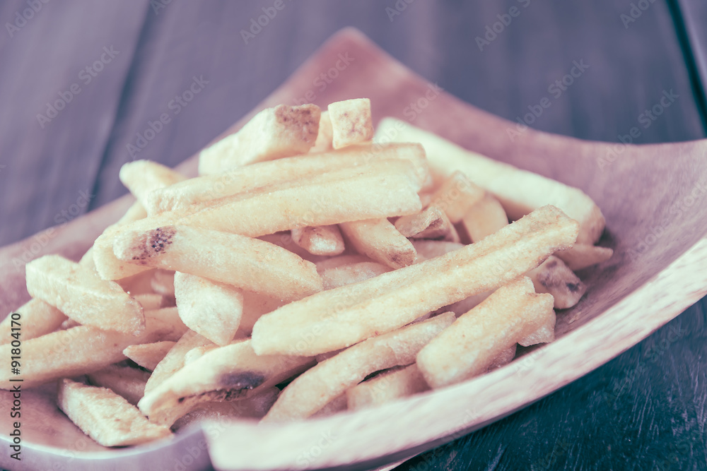 french fries on wood background - soft focus with vintage film f french fries on wood background - soft focus with vintage film f
