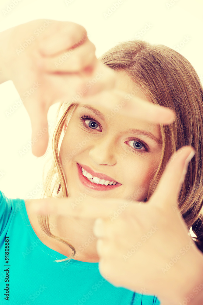 Young woman creating frame with fingers Young woman creating frame with fingers