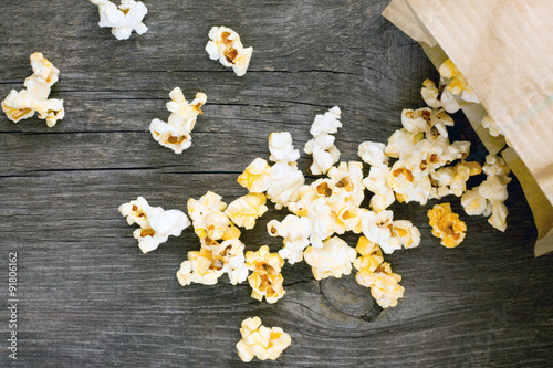 Salty popcorn on a dark gray wooden background