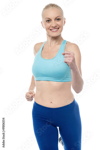 Fit woman in jogging posture