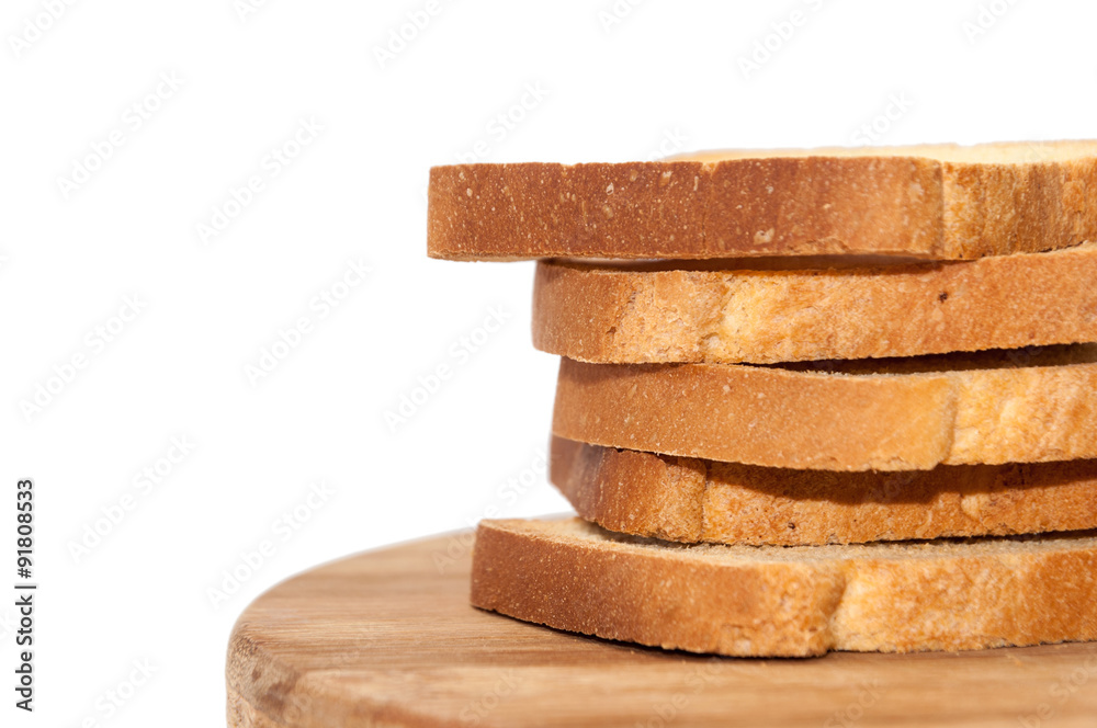 Tower of crunchy bread toast on the wooden board