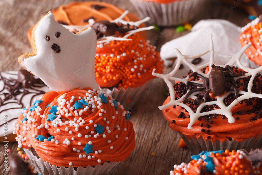 Halloween cupcakes with ghosts and spider close-up. horizontal
