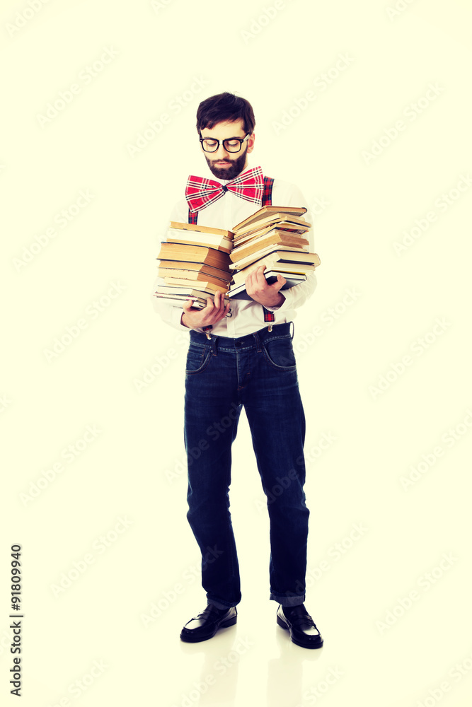 Man wearing suspenders with stack of books. Man wearing suspenders with stack of books.