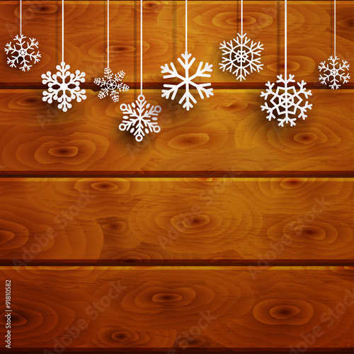Christmas background with hanging snowflakes on wooden planks