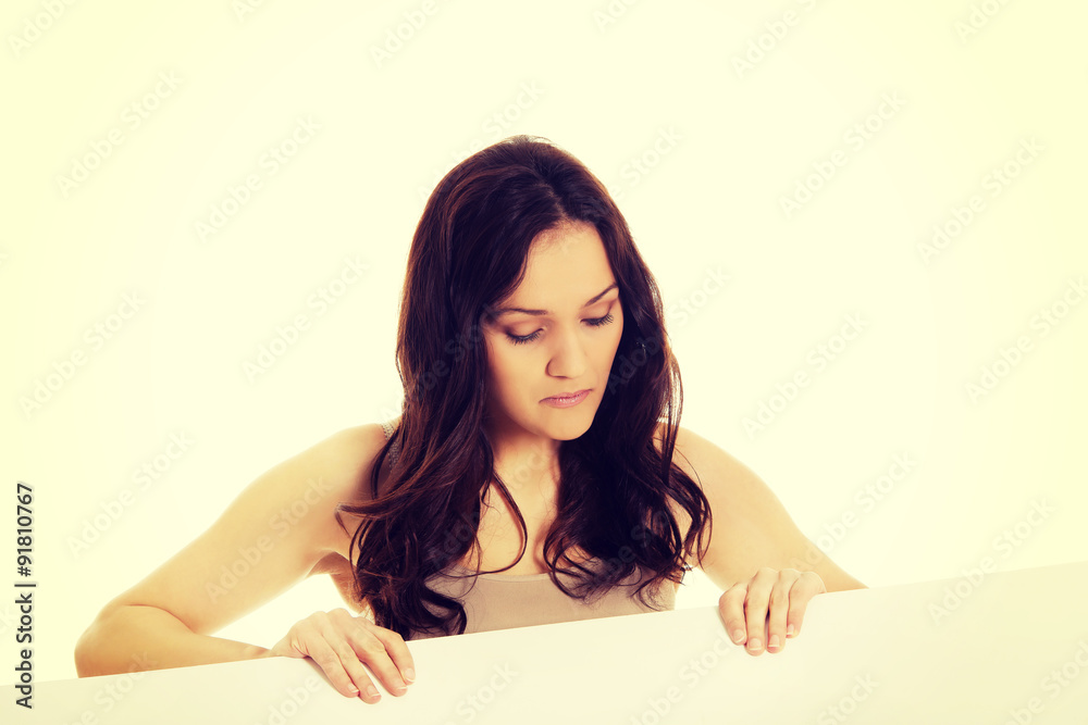 Young woman holding empty banner in hands. Young woman holding empty banner in hands.