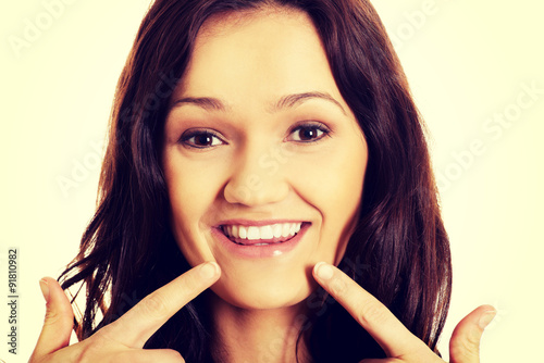 Young woman showing her perfect teeth.