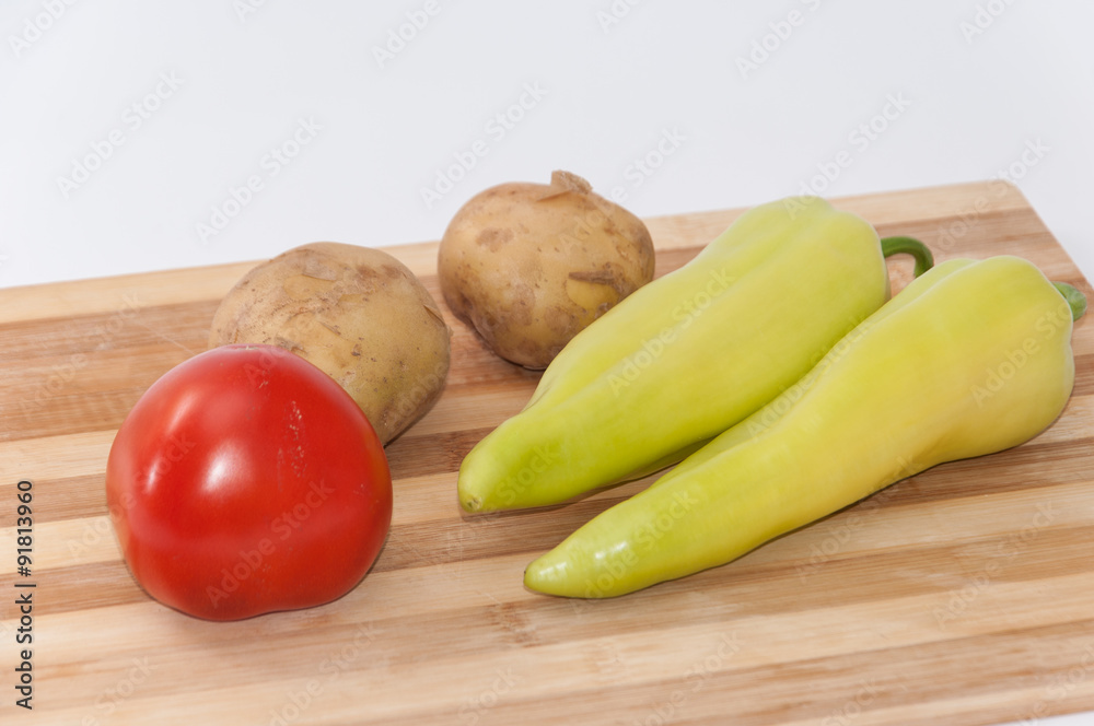 Tomato potato and green paprika on the wooden board Tomato potato and green paprika on the wooden board