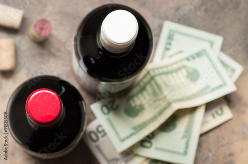 Bottles of wine and dollars top view