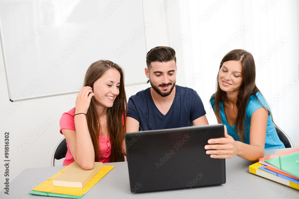 group of young high school students doing teamwork together in a university classroom group of young high school students doing teamwork together in a university classroom