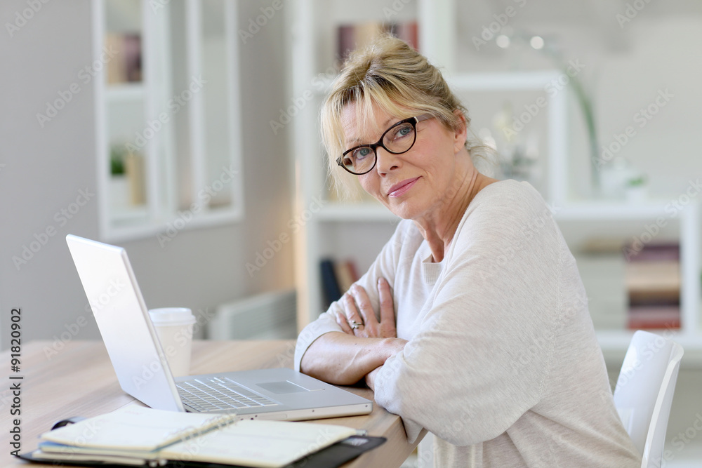 Portrait of senior woman working on laptop computer Portrait of senior woman working on laptop computer