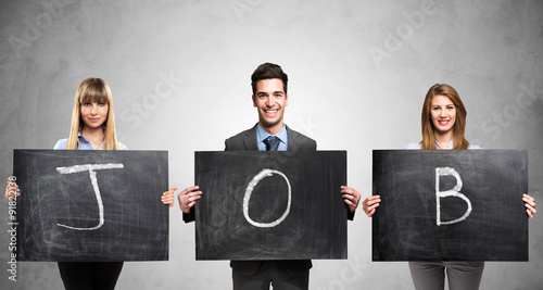 People holding blackboards with the word Job written on