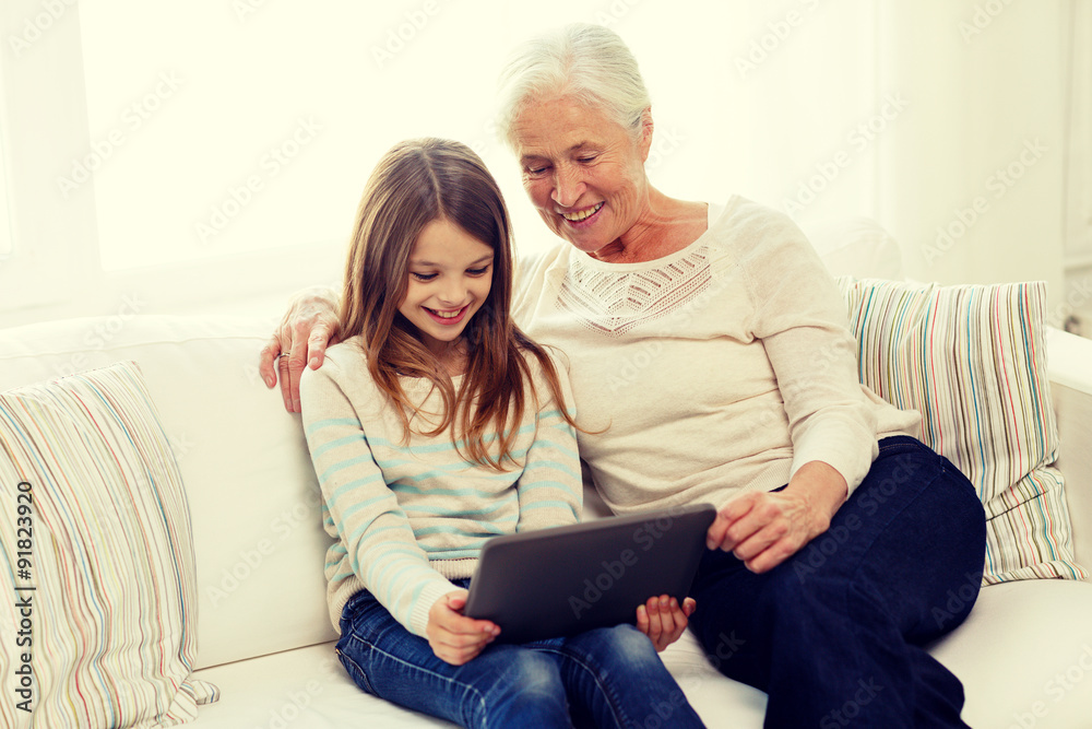 smiling family with tablet pc at home