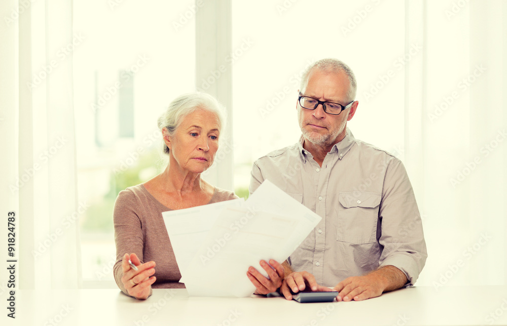 senior couple with papers and calculator at home senior couple with papers and calculator at home