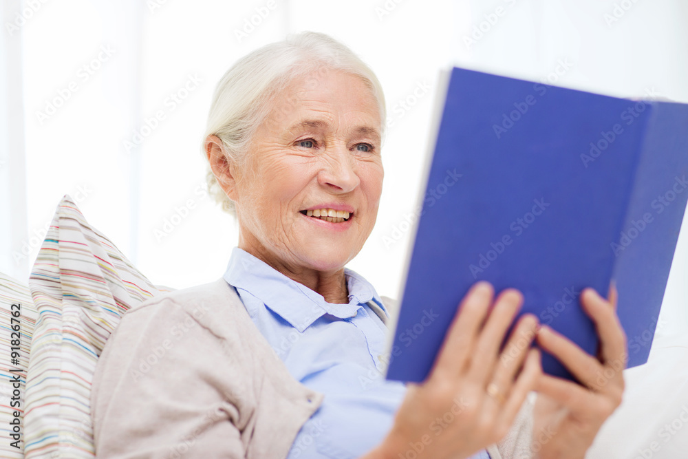 happy smiling senior woman reading book at home happy smiling senior woman reading book at home