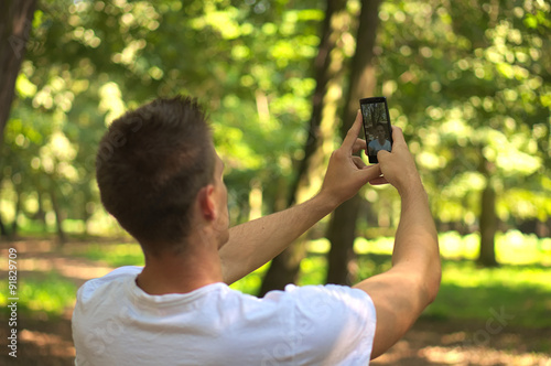 Man talking selfie in forest