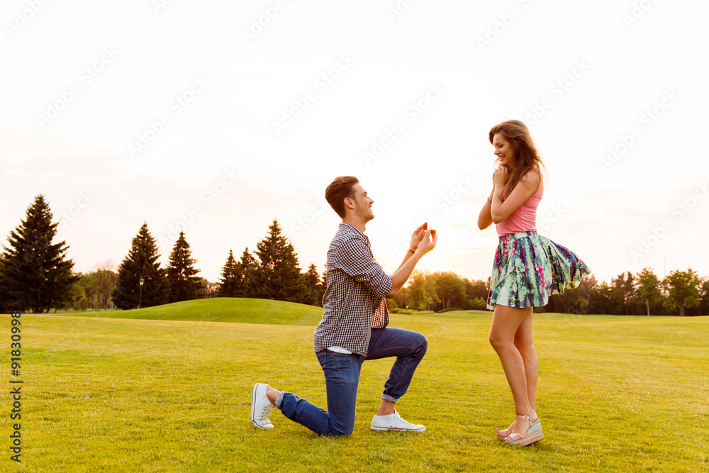 young man makes a proposal of betrothal to his girlfriend young man makes a proposal of betrothal to his girlfriend