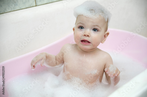 girl taking a bath with foam