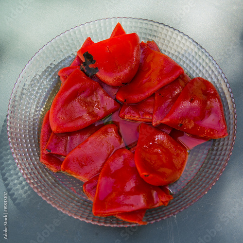 Dish of roasted piquillo red peppers photo