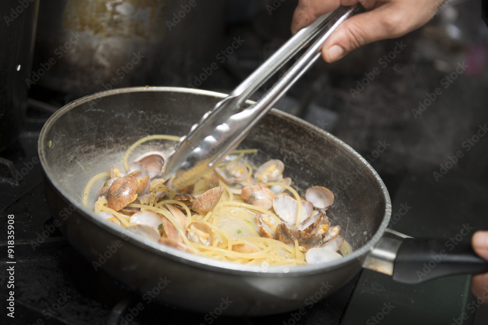 chef is cooking spaghetti alla vongole chef is cooking spaghetti alla vongole