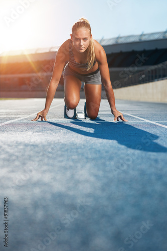 Naklejka Determined sprinter at starting block