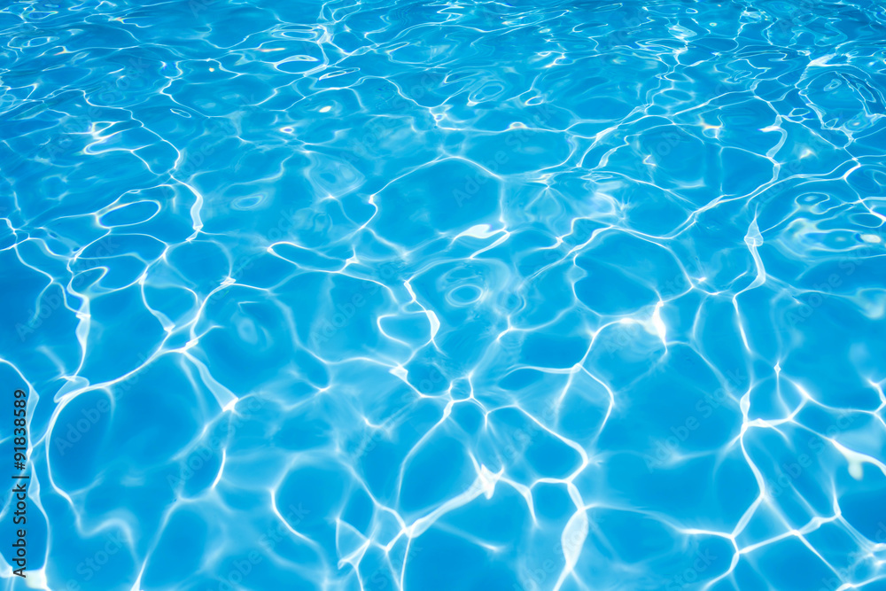 Blue water rippled background in swimming pool