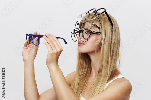 Young blond student choosing spectacles