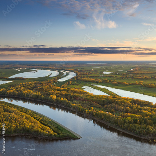 Top view of calm river in autumn evening