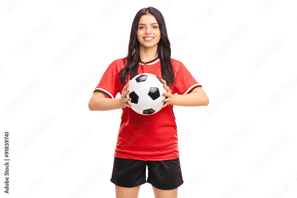 Beautiful female soccer player holding a ball