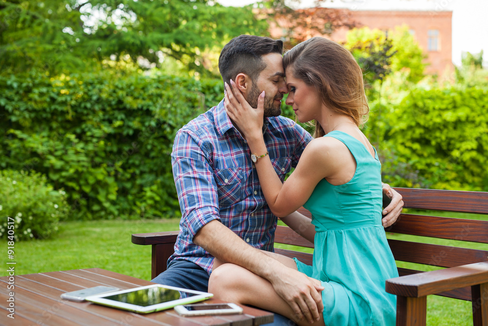 Couple sitting on the bench in garden, they are in love. Couple sitting on the bench in garden, they are in love.