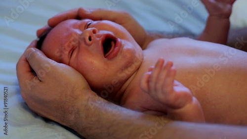 Portret father's hands soothe baby
 photo