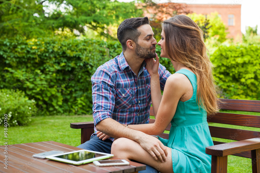 Couple sitting on the bench in garden, they are in love. Couple sitting on the bench in garden, they are in love.