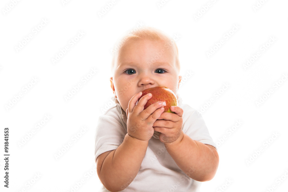 toddler eating an apple on a white background toddler eating an apple on a white background