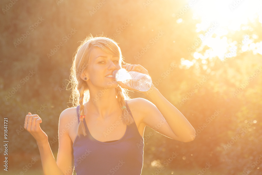 Jogger drinking water after hard exercise. Jogger drinking water after hard exercise.