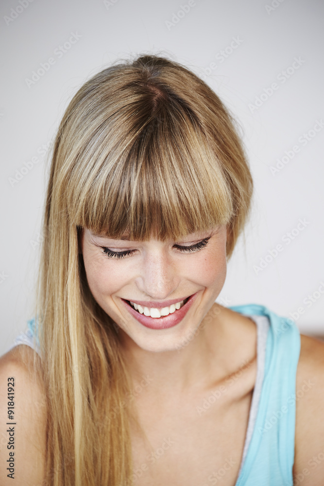 Laughing young woman looking down Laughing young woman looking down