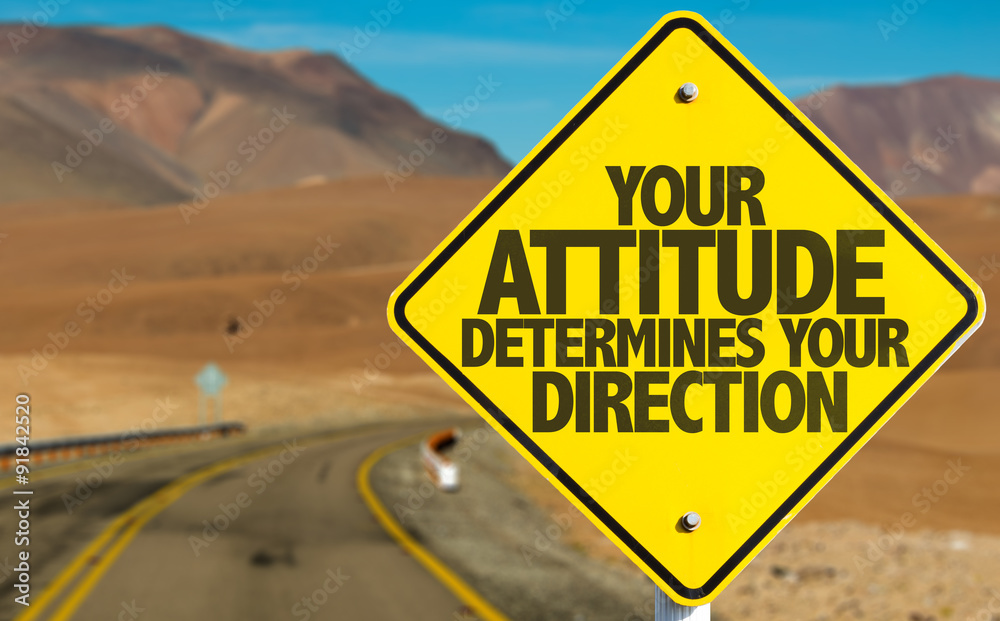 Your Attitude Determines Your Direction sign on desert road