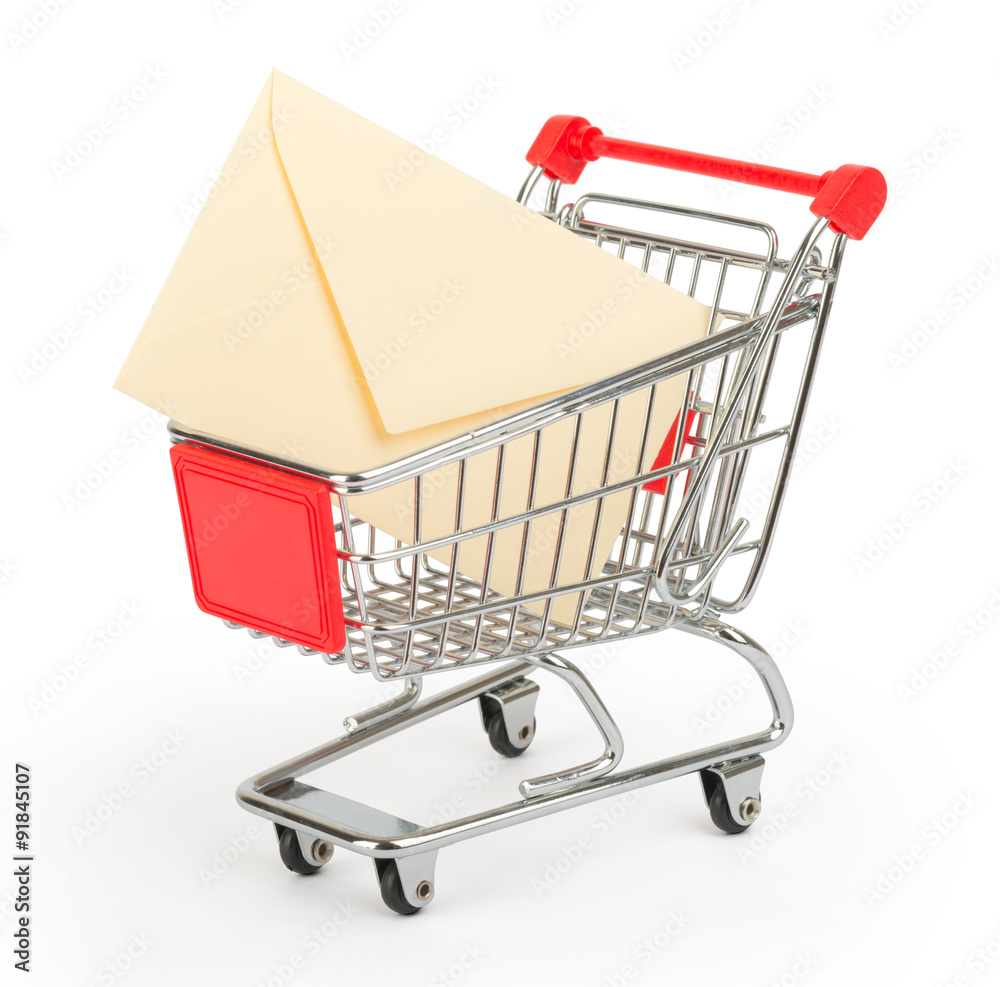 Envelope in shopping cart on white
