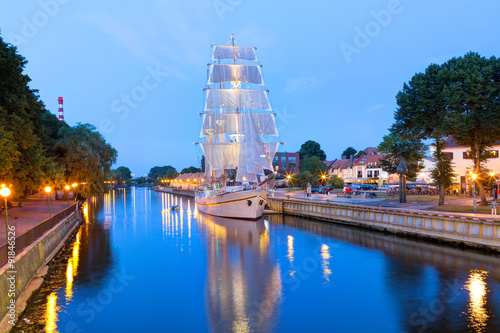  Ship-restaurant is docked on the Danes river. Night scene of Klaipeda old town district. Klaipeda, Lithuania.