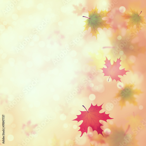 Vintage colorful autumn leaves on blurred bright yellow red bokeh background. Autumn season illustration with copyspace background.