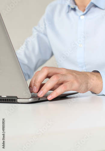Office clerk working on laptop